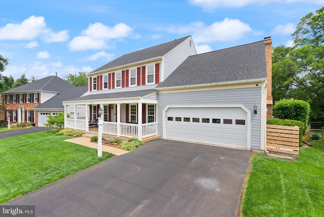 10207 Daylily Ct, Manassas, VA 20110 - colonial house featuring a porch, driveway, and a front lawn
