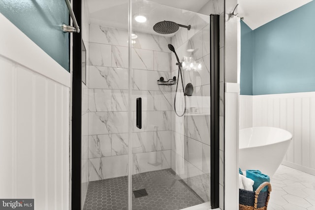 10207 Daylily Ct, Manassas, VA 20110 - bathroom with a freestanding tub, a stall shower, wainscoting, and marble look tiles