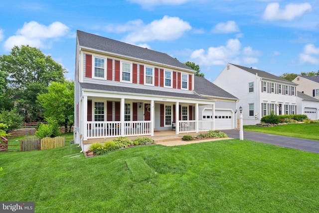 10207 Daylily Ct, Manassas, VA 20110 - colonial home with covered porch, driveway, and an attached garage