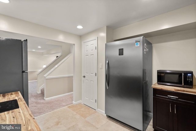 10207 Daylily Ct, Manassas, VA 20110 - kitchen featuring stainless steel appliances, wood counters, light carpet, and recessed lighting