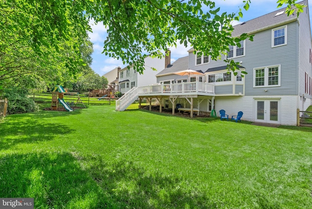 10207 Daylily Ct, Manassas, VA 20110 - rear view of house with a deck, a playground, french doors, and stairs