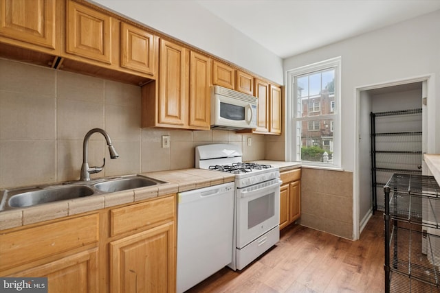 363 E Sharpnack St, Philadelphia, PA 19119 - kitchen with white appliances, tile counters, light wood finished floors, and tasteful backsplash