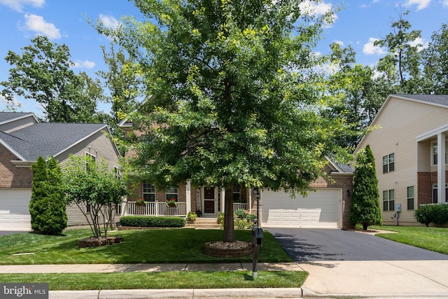 5696 Liberty Manor Cir, Woodbridge, VA 22193 - obstructed view of property with driveway, brick siding, an attached garage, a front lawn, and a porch
