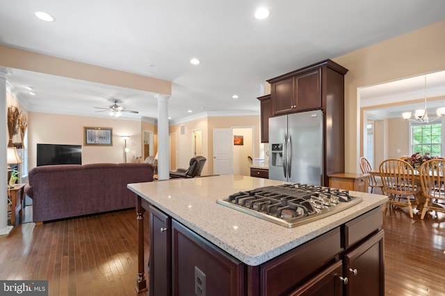 5696 Liberty Manor Cir, Woodbridge, VA 22193 - kitchen featuring appliances with stainless steel finishes, decorative columns, dark wood-style floors, crown molding, and light stone counters