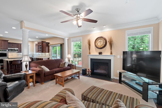 5696 Liberty Manor Cir, Woodbridge, VA 22193 - living room featuring ornate columns, a glass covered fireplace, ornamental molding, plenty of natural light, and a ceiling fan
