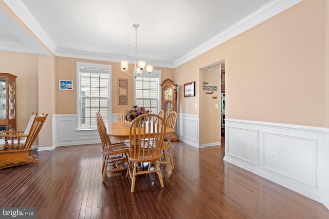 5696 Liberty Manor Cir, Woodbridge, VA 22193 - dining room featuring a chandelier, dark wood-style flooring, a wainscoted wall, crown molding, and a decorative wall
