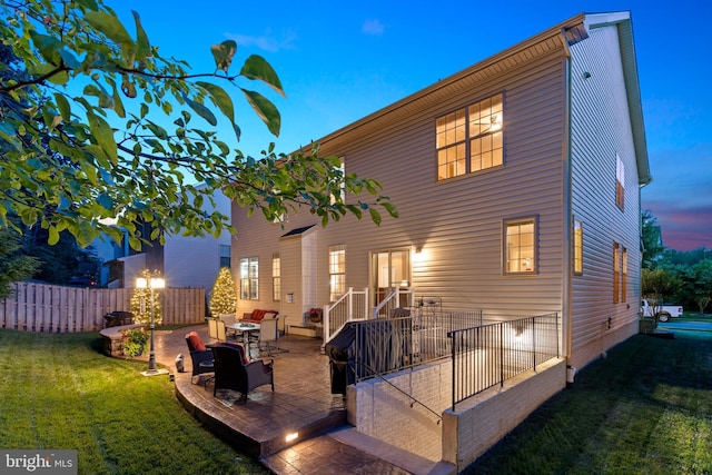 5696 Liberty Manor Cir, Woodbridge, VA 22193 - back of house at dusk with a patio area