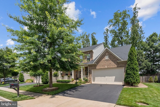 5696 Liberty Manor Cir, Woodbridge, VA 22193 - view of front facade with asphalt driveway, brick siding, an attached garage, and roof with shingles
