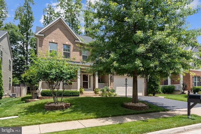 5696 Liberty Manor Cir, Woodbridge, VA 22193 - view of front of home featuring brick siding, driveway, a front lawn, and a porch