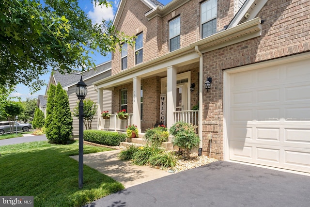 5696 Liberty Manor Cir, Woodbridge, VA 22193 - view of front of house with a porch, brick siding, a garage, and a front lawn