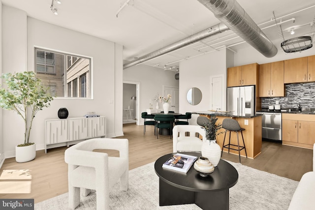 301 Massachusetts Ave NW Unit 1103, Washington, DC 20001 - living area with rail lighting and wood finished floors