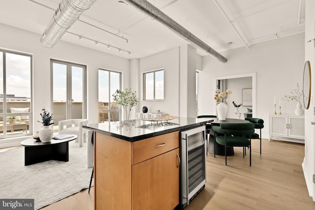 301 Massachusetts Ave NW Unit 1103, Washington, DC 20001 - kitchen with wine cooler, light wood finished floors, a center island, and a breakfast bar area