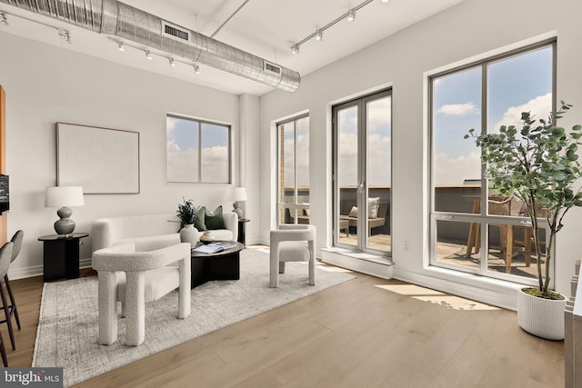 301 Massachusetts Ave NW Unit 1103, Washington, DC 20001 - living area featuring rail lighting, wood finished floors, and healthy amount of natural light