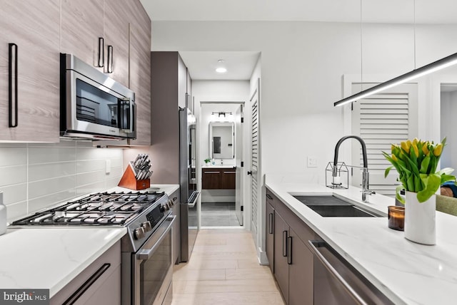 1471 Harvard St NW Unit 2, Washington, DC 20009 - kitchen with appliances with stainless steel finishes, light stone counters, tasteful backsplash, modern cabinets, and recessed lighting
