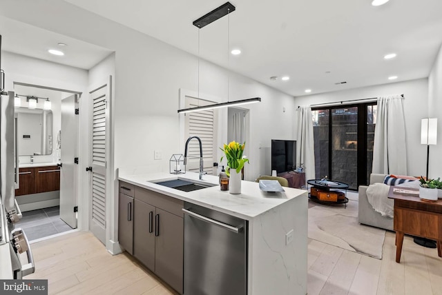 1471 Harvard St NW Unit 2, Washington, DC 20009 - kitchen with dishwasher, open floor plan, a peninsula, light stone counters, and light wood-style flooring
