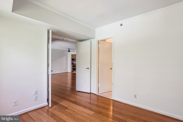1200 Crystal Dr Unit 514, Arlington, VA 22202 - empty room featuring wood finished floors, ornamental molding, and ceiling fan