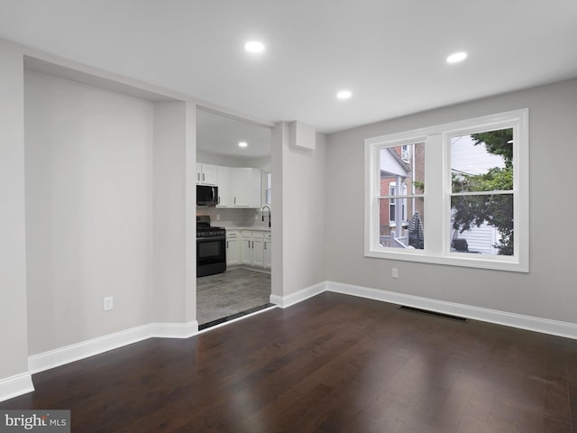 2603 N Tatnall St, Wilmington, DE 19802 - unfurnished living room with dark wood-style flooring and recessed lighting