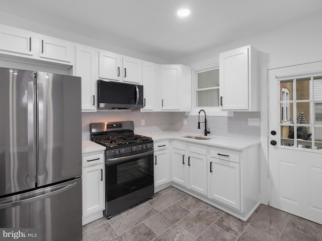 2603 N Tatnall St, Wilmington, DE 19802 - kitchen featuring appliances with stainless steel finishes, light countertops, white cabinets, and backsplash