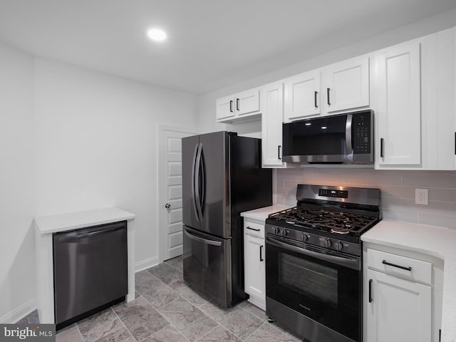 2603 N Tatnall St, Wilmington, DE 19802 - kitchen with appliances with stainless steel finishes, light countertops, white cabinets, and backsplash