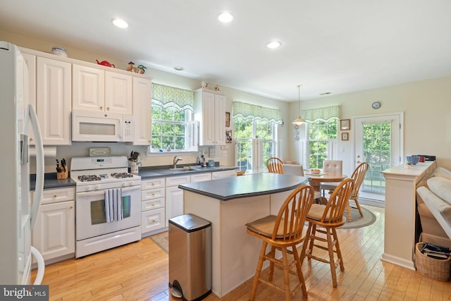 8 Spout Ter, Barnegat, NJ 08005 - kitchen featuring white appliances, dark countertops, light wood-style flooring, a breakfast bar, and recessed lighting