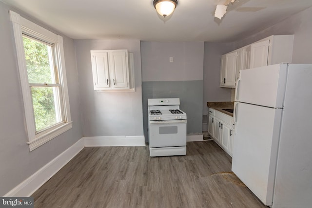 2149 Harford Rd, Baltimore, MD 21218 - kitchen featuring white appliances, wood finished floors, white cabinetry, and plenty of natural light
