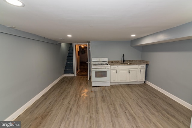 2149 Harford Rd, Baltimore, MD 21218 - kitchen featuring gas range gas stove, white cabinets, light wood finished floors, light stone counters, and recessed lighting