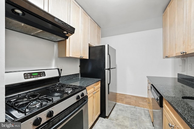922 24th St NW Unit 504, Washington, DC 20037 - kitchen with stainless steel appliances, ventilation hood, light brown cabinetry, and dark stone counters