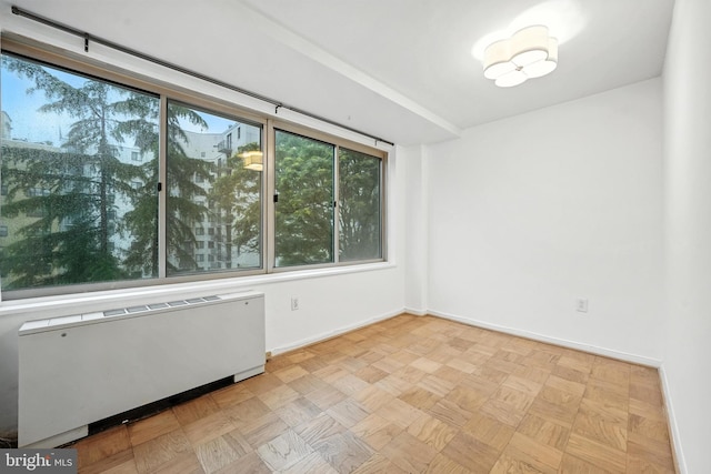 922 24th St NW Unit 504, Washington, DC 20037 - empty room featuring radiator heating unit and baseboards