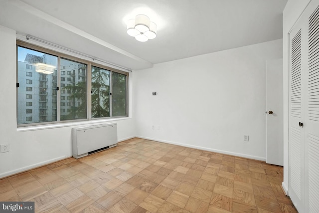 922 24th St NW Unit 504, Washington, DC 20037 - spare room featuring radiator and baseboards