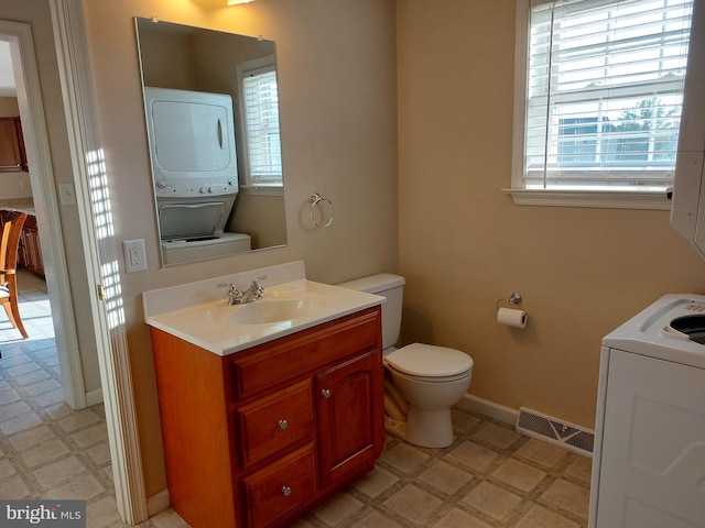323 Swatara Creek Dr, Jonestown, PA 17038 - bathroom with tile patterned floors, stacked washer / dryer, plenty of natural light, and vanity