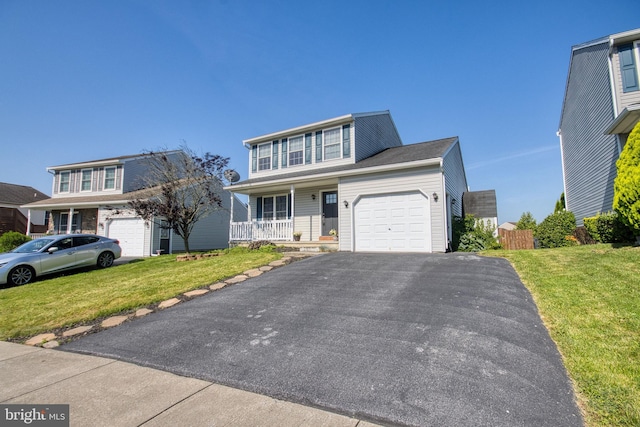 323 Swatara Creek Dr, Jonestown, PA 17038 - traditional-style house featuring a garage, covered porch, asphalt driveway, and a front lawn