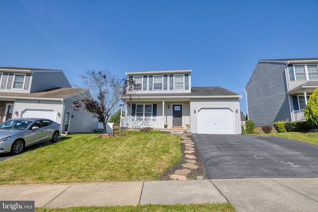 323 Swatara Creek Dr, Jonestown, PA 17038 - traditional home featuring an attached garage, a porch, driveway, and a front lawn