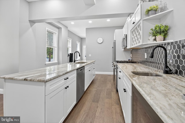 30 Race Ave, Lancaster, PA 17603 - kitchen featuring stainless steel appliances, open shelves, wood finished floors, a center island with sink, and recessed lighting