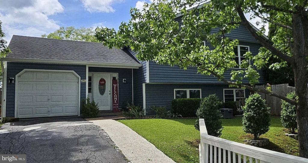 215 Choptank Rd, Stafford, VA 22556 - view of front of house with an attached garage, driveway, and a shingled roof