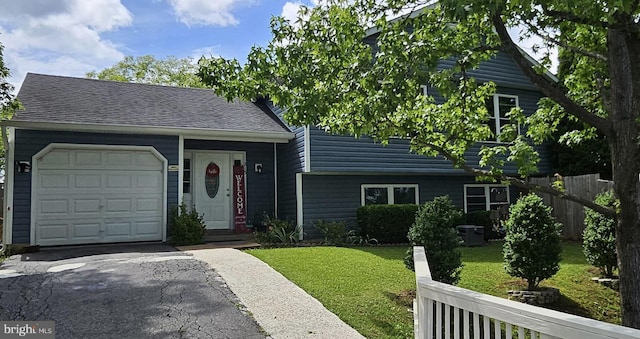 215 Choptank Rd, Stafford, VA 22556 - view of front of house with an attached garage, driveway, and a shingled roof