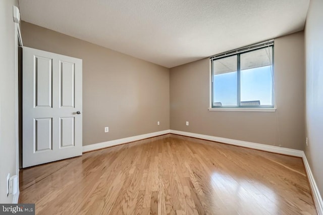 414 Water St Unit 2814, Baltimore, MD 21202 - unfurnished room featuring light wood-style floors and a textured ceiling