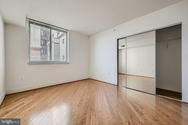 414 Water St Unit 2814, Baltimore, MD 21202 - unfurnished bedroom with wood finished floors and a closet