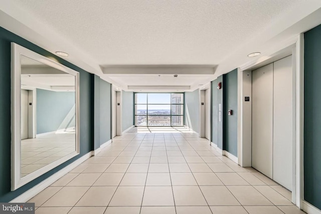 414 Water St Unit 2814, Baltimore, MD 21202 - corridor with a textured ceiling, elevator, and light tile patterned flooring