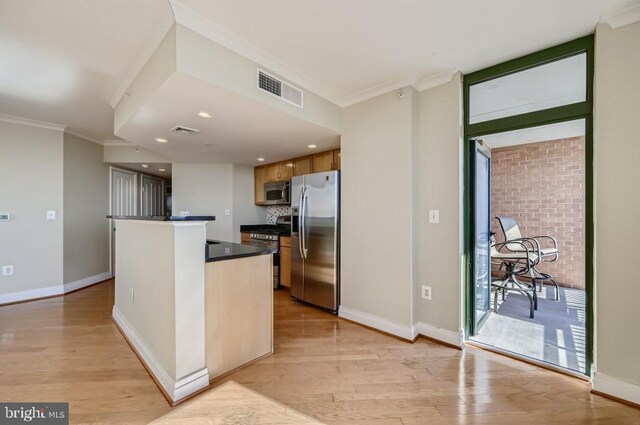 414 Water St Unit 2814, Baltimore, MD 21202 - kitchen with stainless steel appliances, ornamental molding, dark countertops, light wood-style flooring, and recessed lighting
