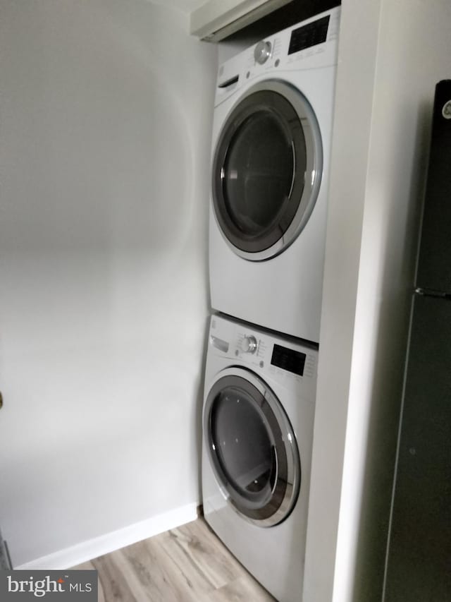 14007 Vista Dr Unit 30, Laurel, MD 20707 - laundry room featuring stacked washing machine and dryer and light wood-style floors
