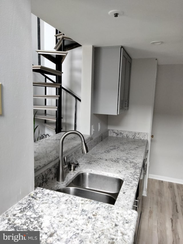 14007 Vista Dr Unit 30, Laurel, MD 20707 - kitchen with gray cabinetry, light wood-style flooring, and light stone counters