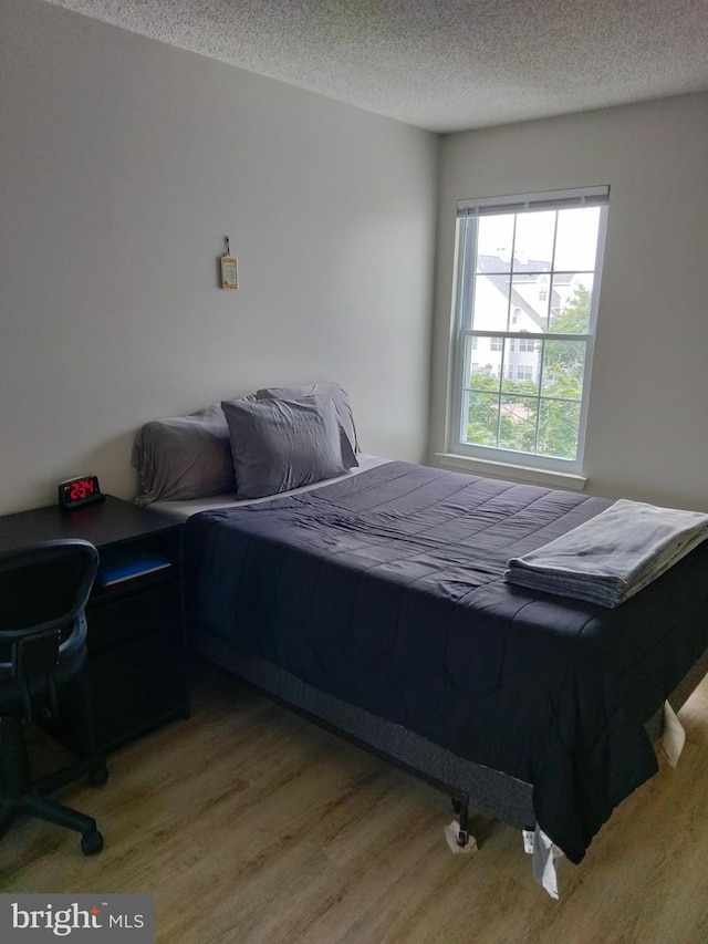 14007 Vista Dr Unit 30, Laurel, MD 20707 - bedroom with light wood finished floors and a textured ceiling