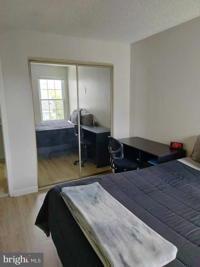 14007 Vista Dr Unit 30, Laurel, MD 20707 - bedroom with wood finished floors, a textured ceiling, and a closet