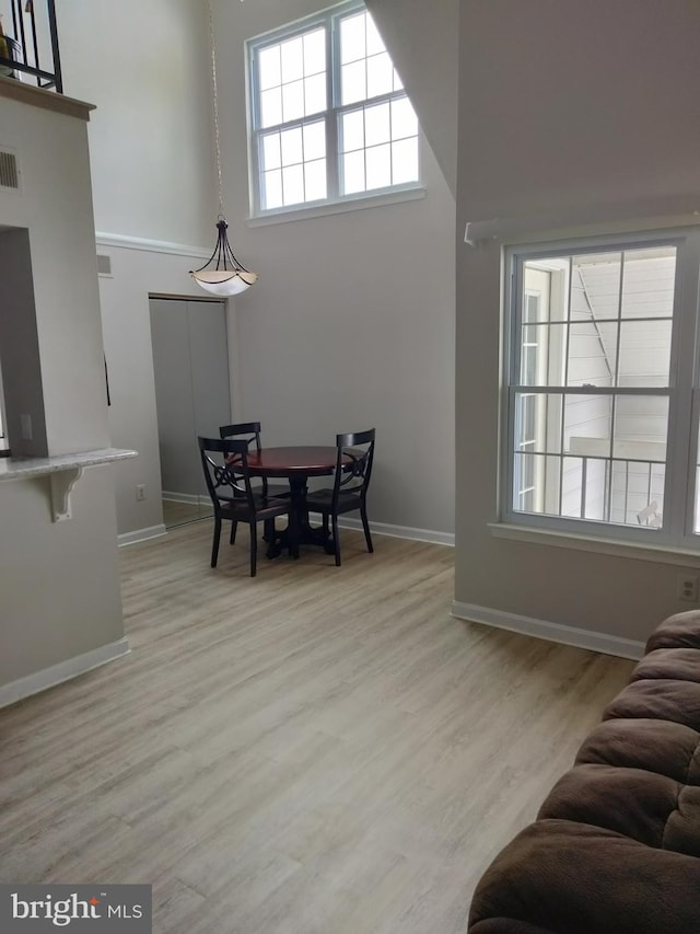 14007 Vista Dr Unit 30, Laurel, MD 20707 - dining space featuring light wood-style flooring and a towering ceiling