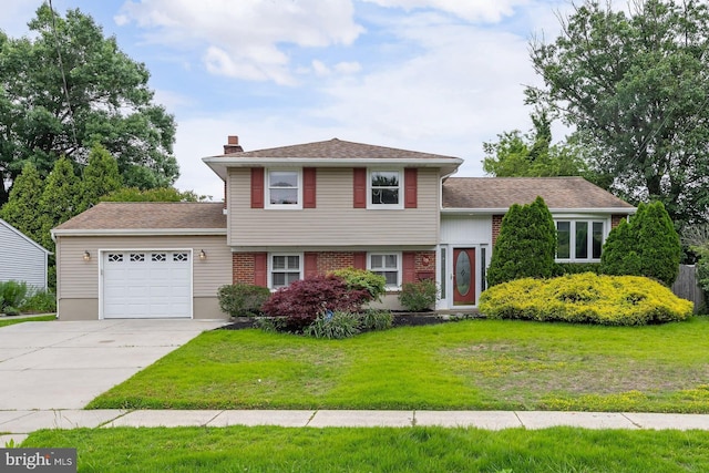 19 Timber Creek Rd, Stratford, NJ 08084 - tri-level home featuring a garage, driveway, a front yard, and a chimney
