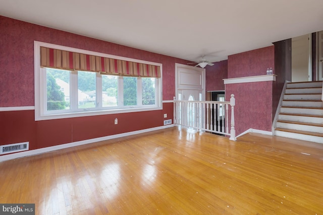 19 Timber Creek Rd, Stratford, NJ 08084 - unfurnished living room with wood-type flooring, ceiling fan, and stairway
