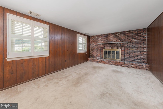 19 Timber Creek Rd, Stratford, NJ 08084 - unfurnished living room with wood walls, a brick fireplace, and carpet flooring