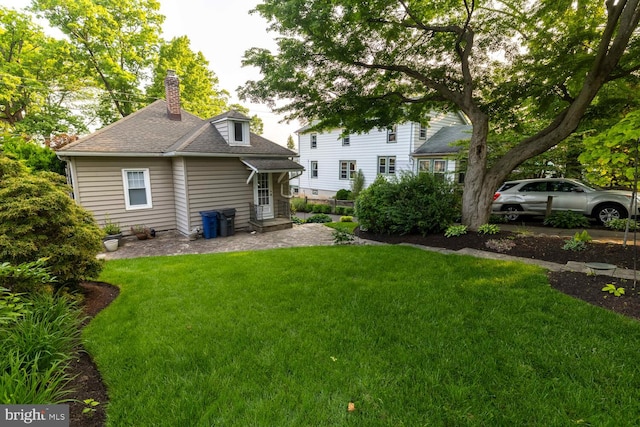 671 Edge Hill Rd, Glenside, PA 19038 - back of property with a lawn, a chimney, and roof with shingles
