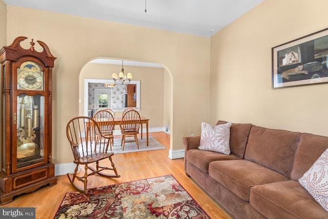671 Edge Hill Rd, Glenside, PA 19038 - living area featuring arched walkways, a chandelier, and light wood-style floors