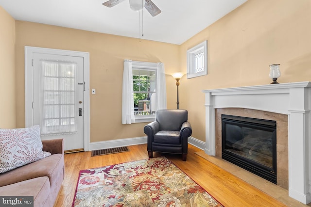 671 Edge Hill Rd, Glenside, PA 19038 - living room featuring a tiled fireplace, wood finished floors, and a ceiling fan